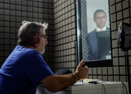 Man having a hearing test in a soundproofed booth