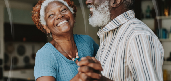 Happy older couple dancing to music carefree and hearing clearly.