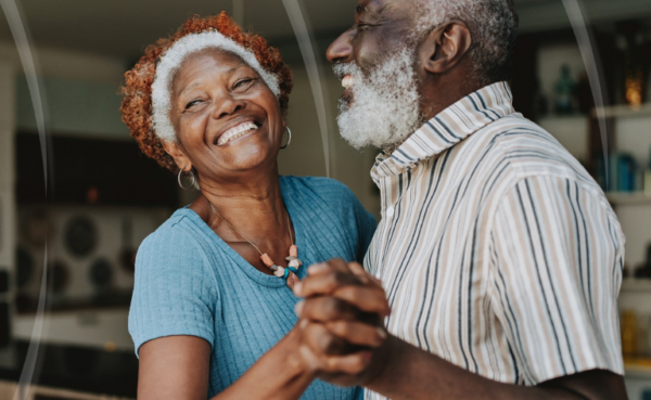 Happy older couple dancing to music carefree and hearing clearly.