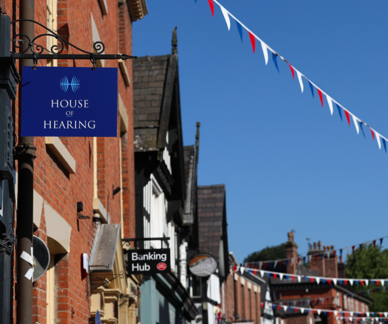 Branded hanging sign for House of Hearing Knutsford on King Street.