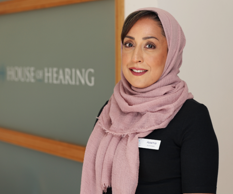 Audiologist Aasma standing in the main reception at House of Hearing Lichfield.