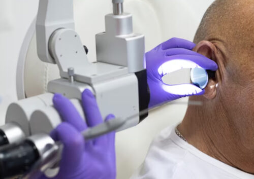 Gentleman over the age of 75 enjoying his free earwax removal service at House of Hearing.