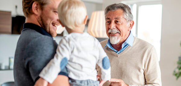 Man with his young son and his father, hearing clearly and enjoying a moment of connection.