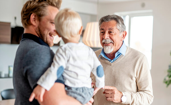 Man with his young son and his father, hearing clearly and enjoying a moment of connection.
