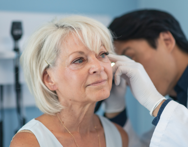Woman having her ears examined by a specialist.